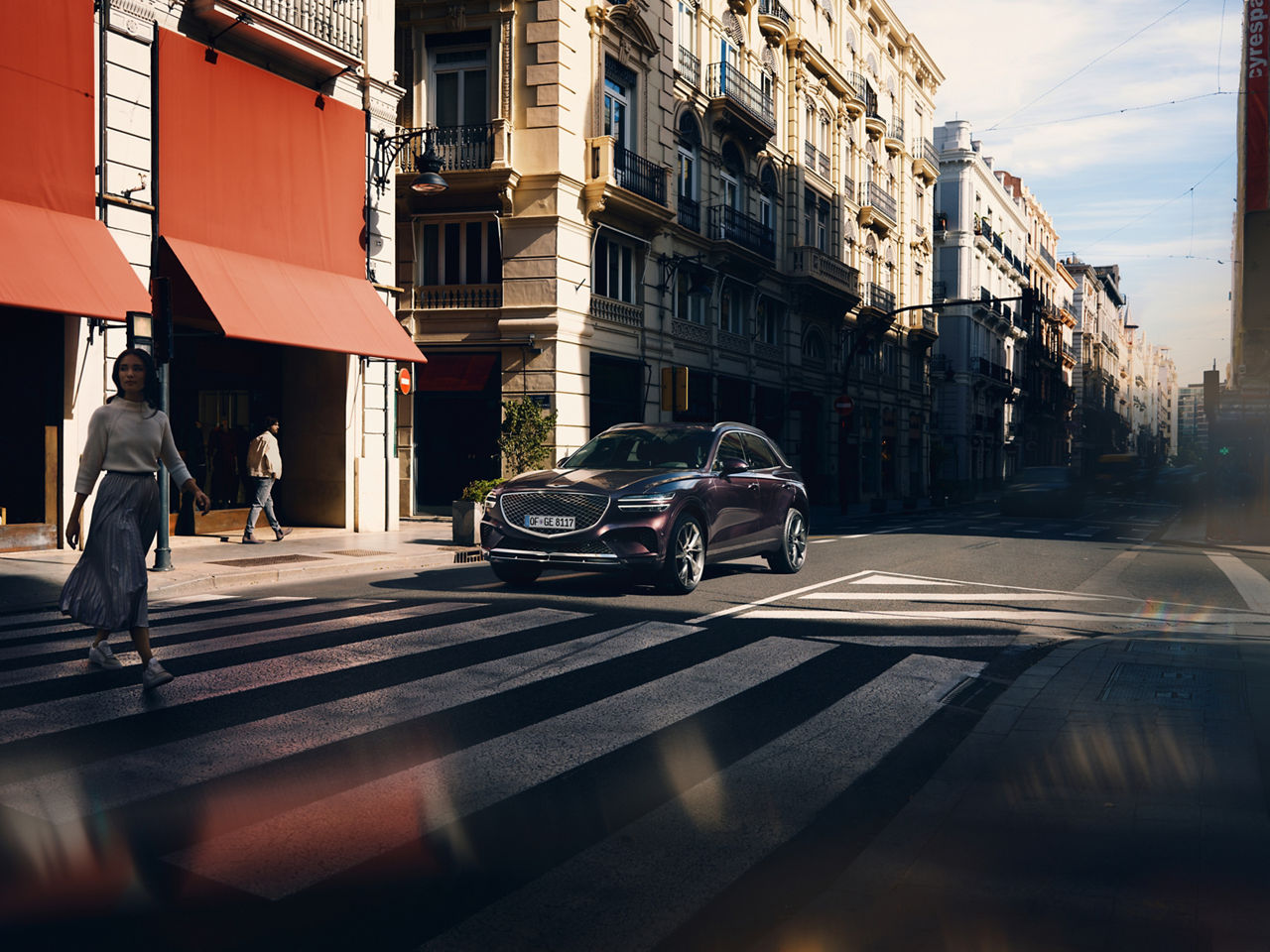 A car stops at a zebra crossing in the city