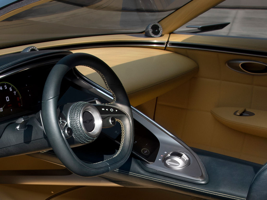 Steering wheel in the brown interior of the Genesis X Speedium 