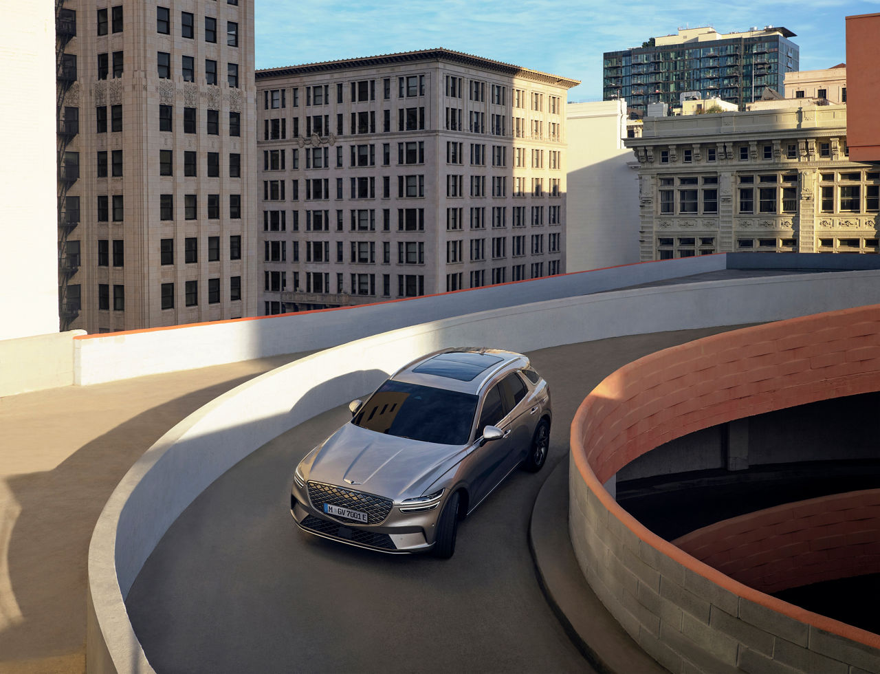 Grey Genesis GV70 drives down the ramp of a multi-storey car park