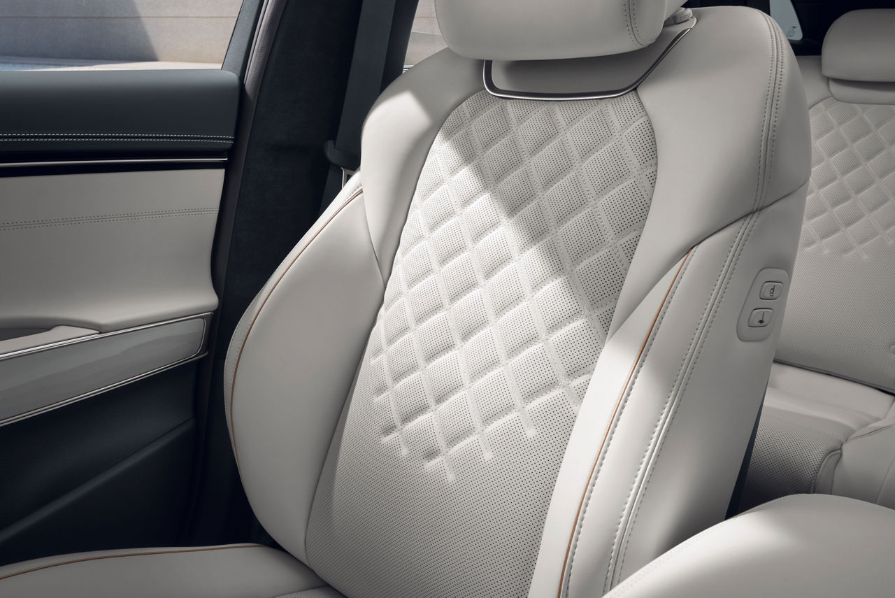 Detail of the front passenger seat in nappa white in the Genesis Electrified GV70