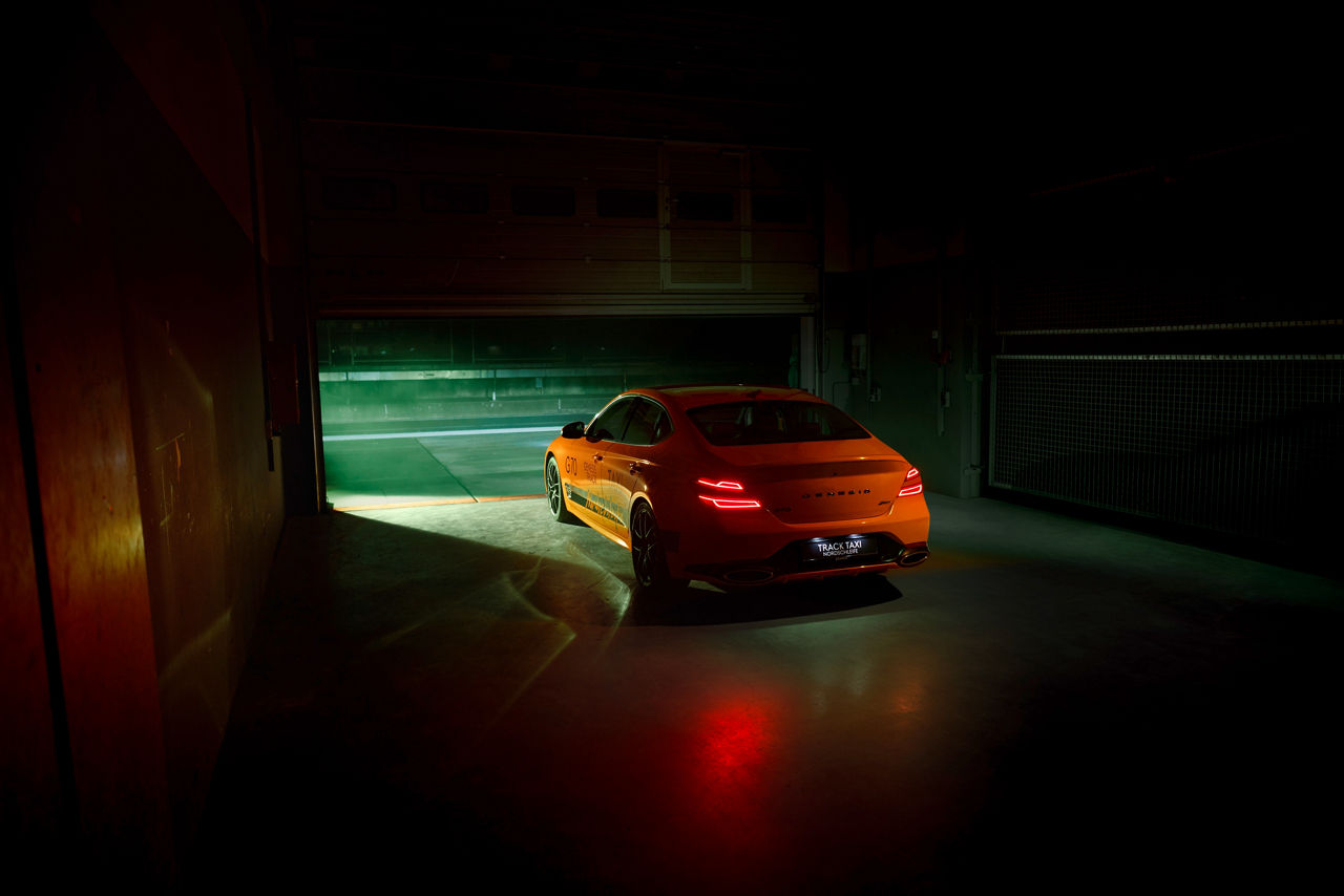 Genesis G70 Magma Track Taxi drives out of the garage in the dark