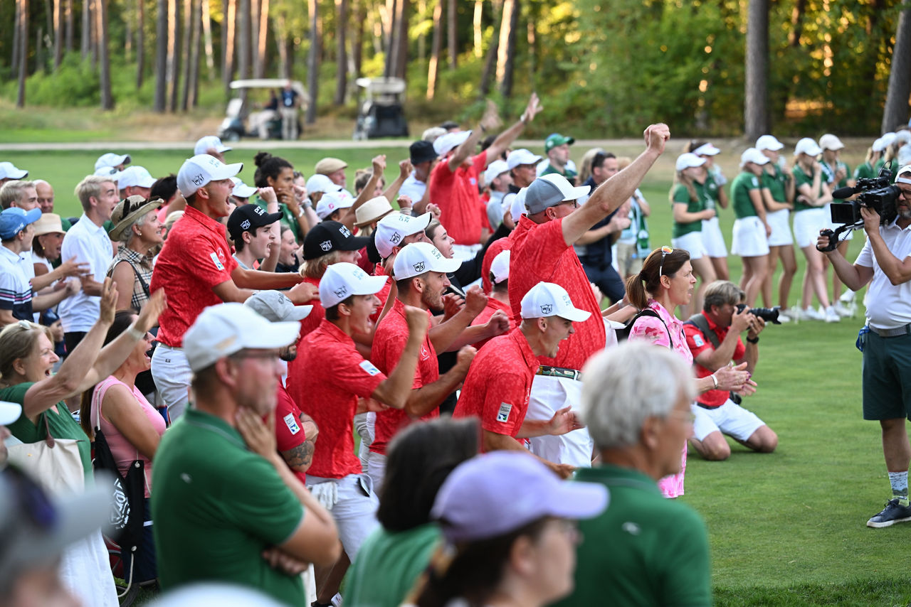 Spectators celebrating on a golf course
