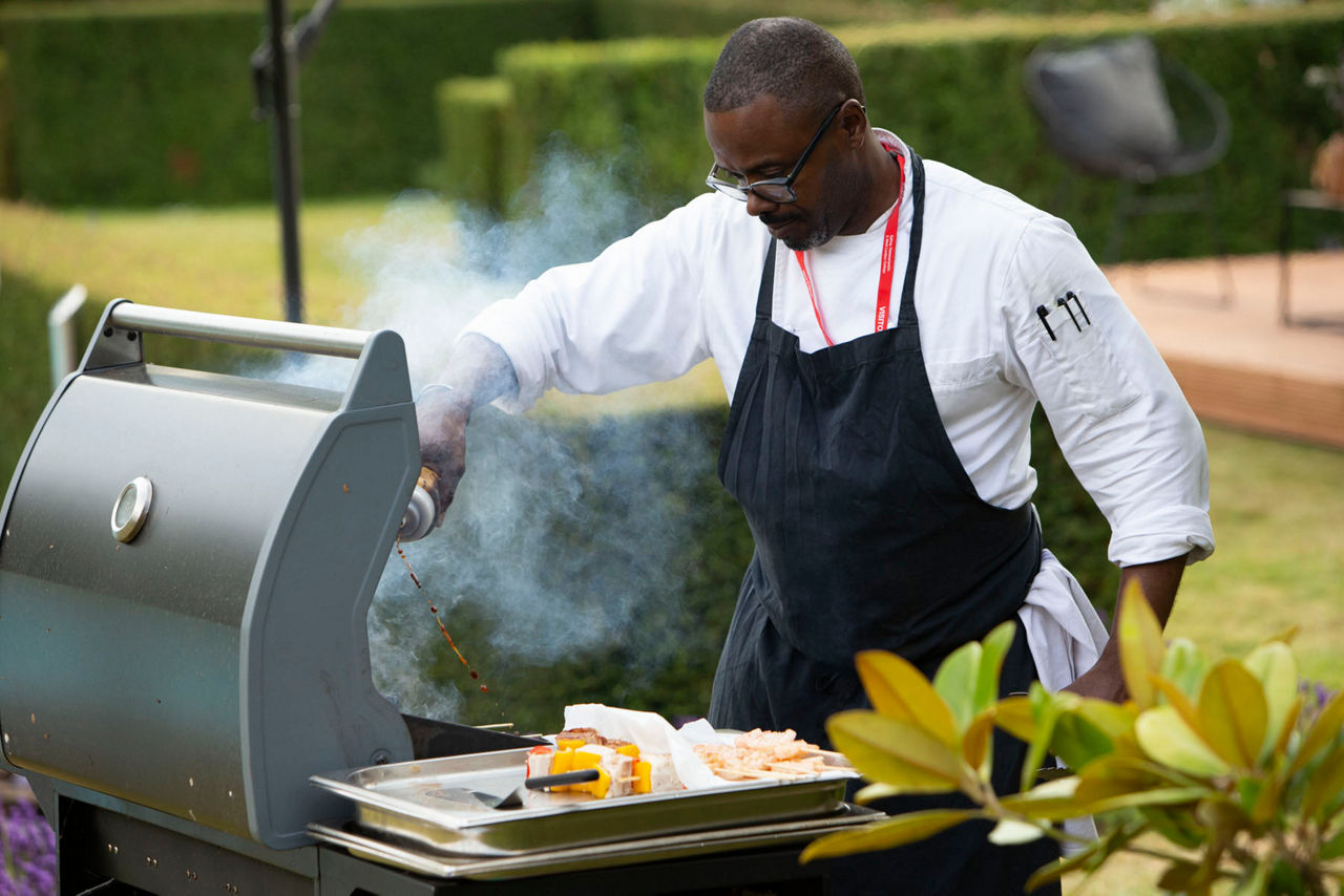 Man standing at a barbecue 