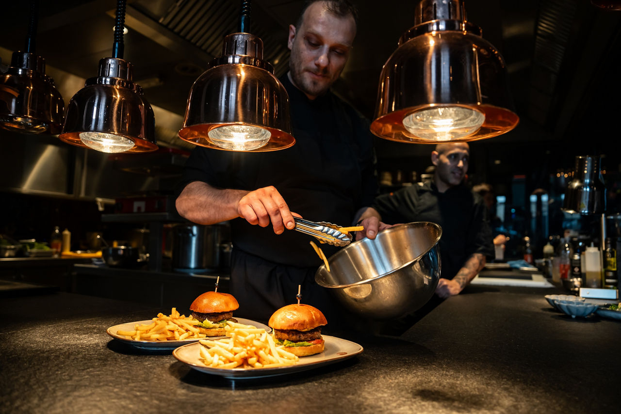 Chef perparing burger and fries on Myle festival