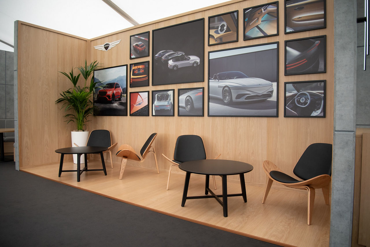 Sitting area with photos of cars on the wall