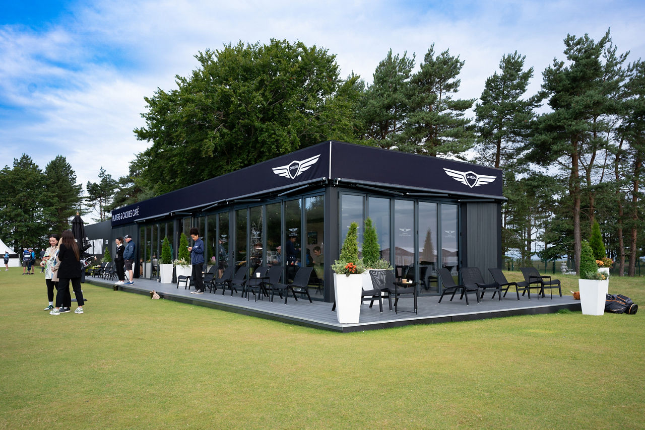Cafe on a golf course with people in front of it