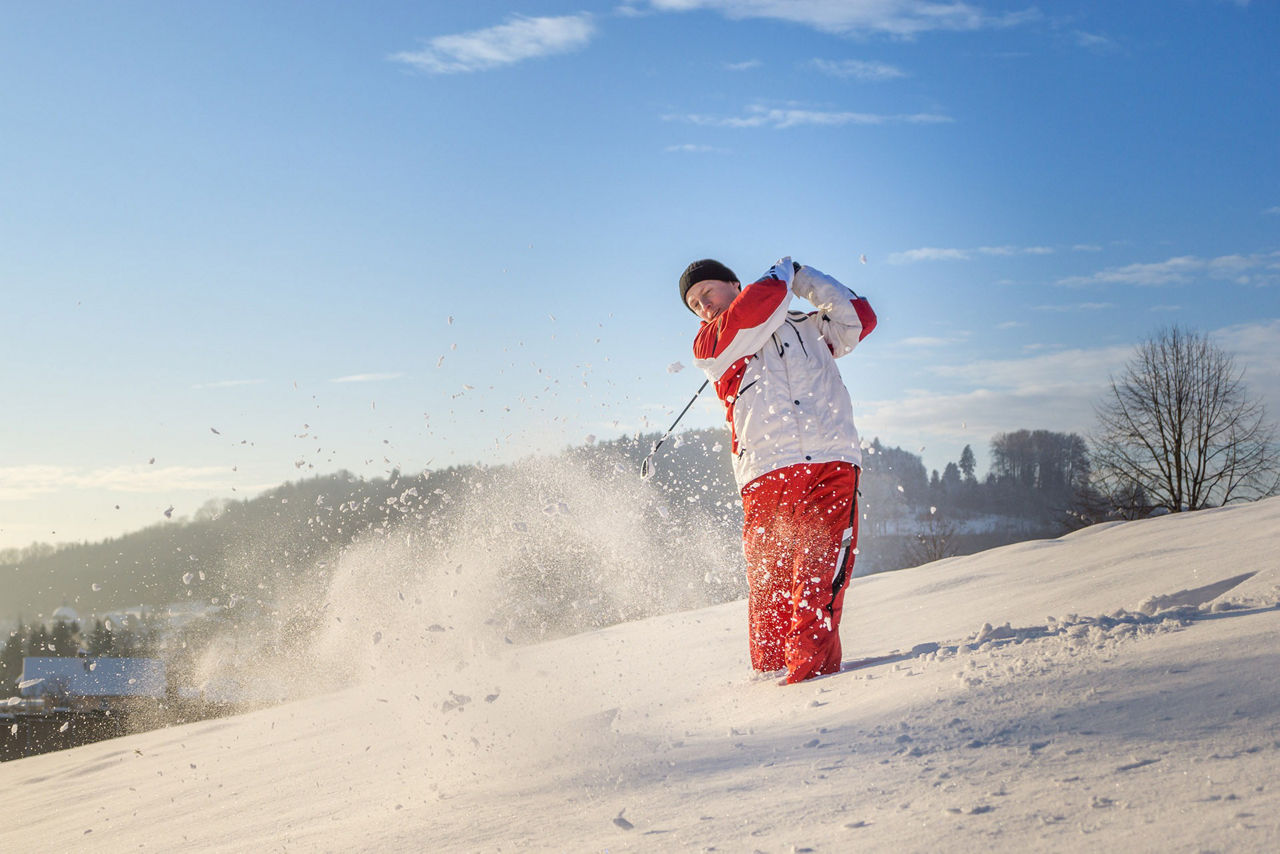 Golfer outdoor playing snow golf