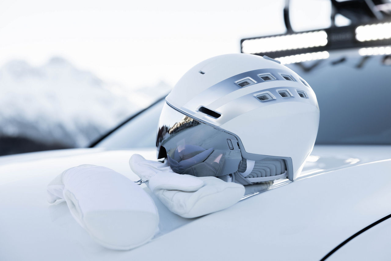 White helmet and gloves on a white bonnet