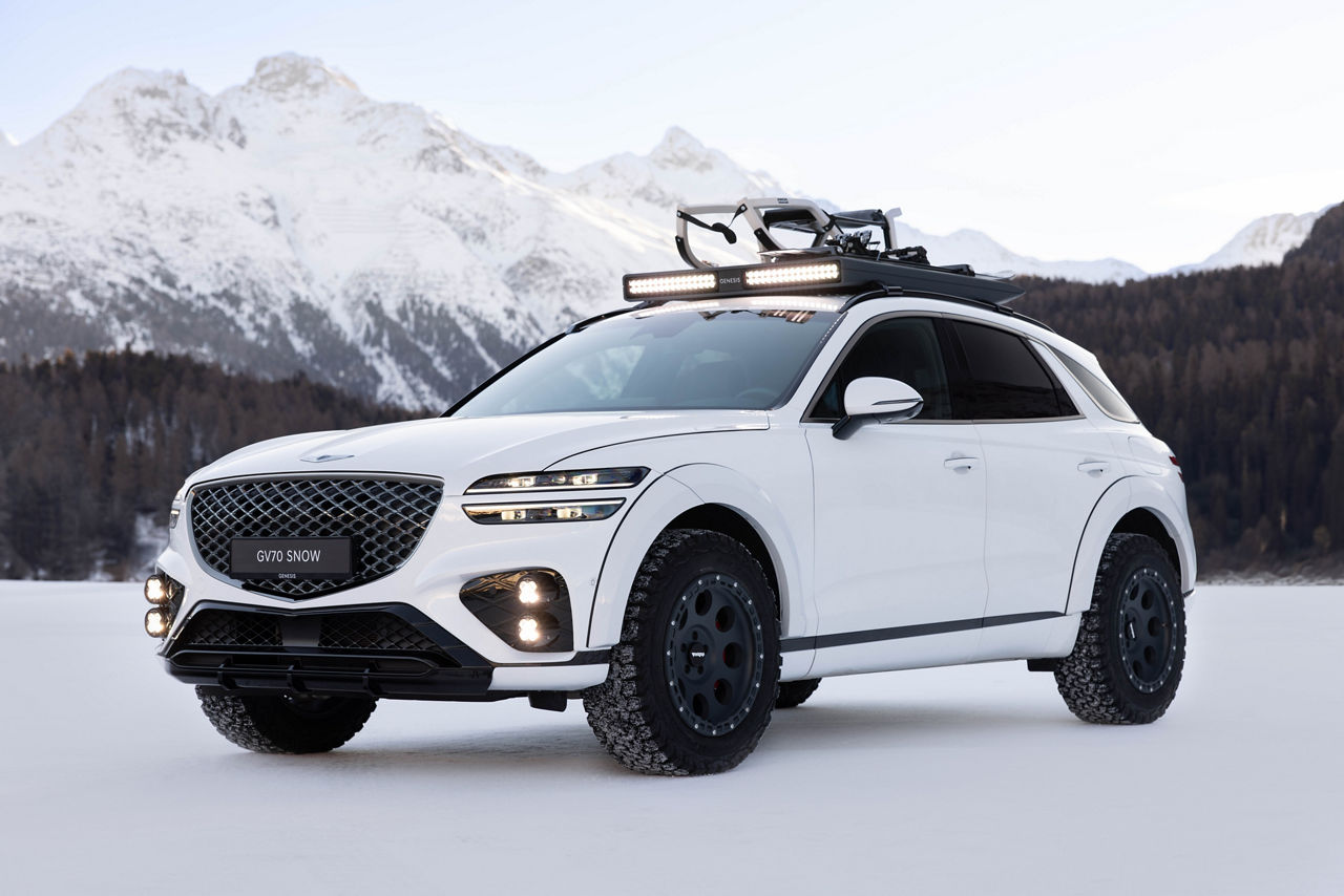 White GV70 Snow Concept front view on snow against a mountain backdrop