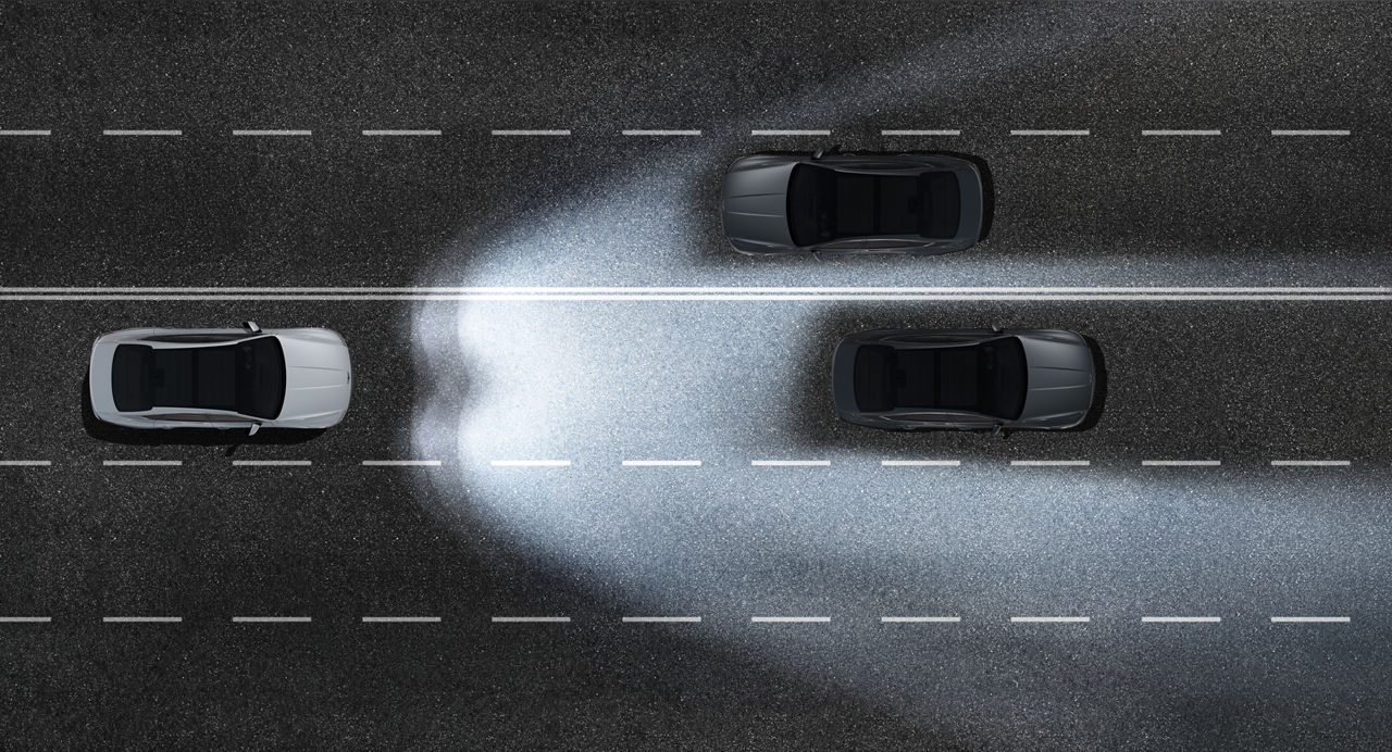 Graphic of the light cone of the headlights of a car on a road with two other cars in the dark
