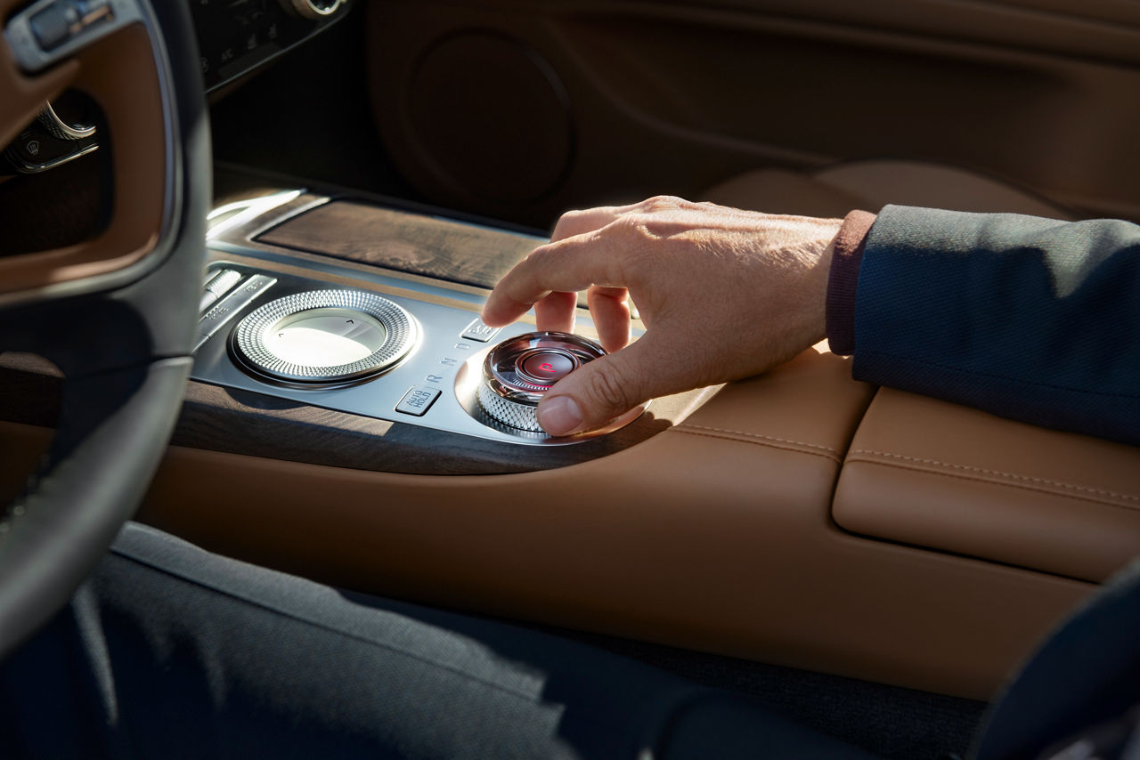 Person uses dial in the centre console of a Genesis G80
