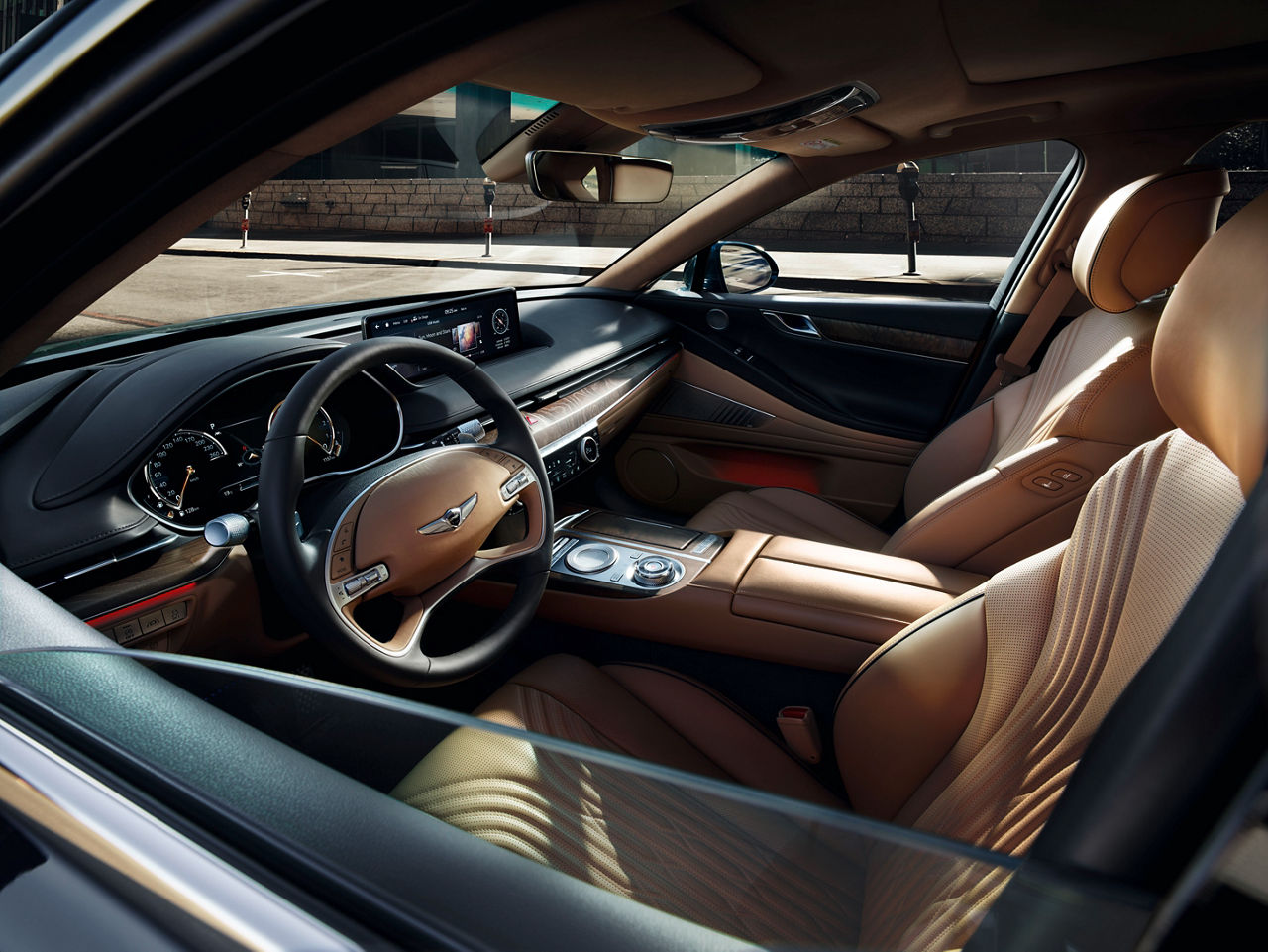 View through the window of the front compartment of the Genesis G80 with beige and black interior