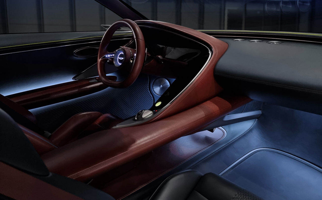 Detail of the steering wheel and dashboard in brown black from the Genesis X Concept