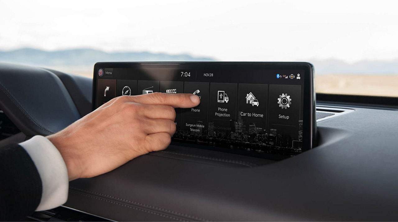 Person operates the infotainment display in a car