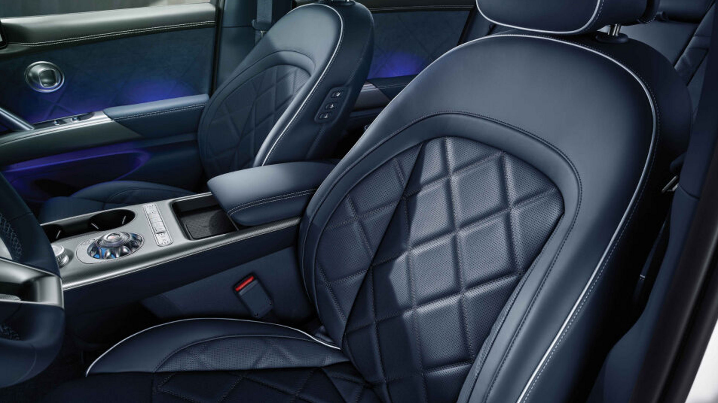 The interior of the front seat of the Genesis GV60, with he texture of the leather seats is highlighted.