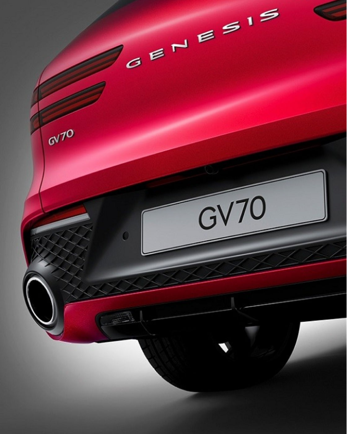 Rear close-up of a red GV70 showcasing its aggressive bumper design and exhaust details.