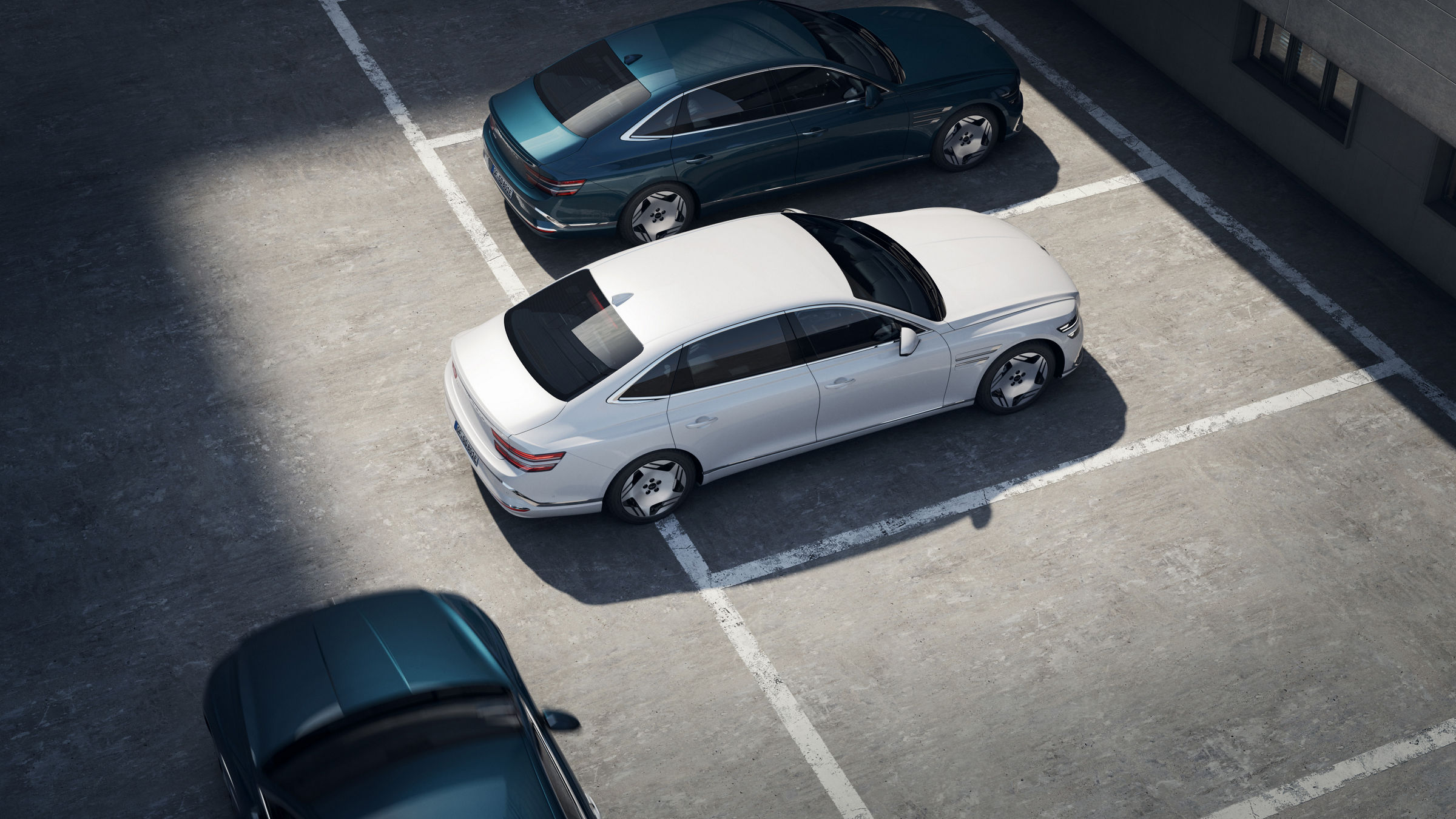 Another vehicle is approaching the rear of an Electrified G80 that is backing out of a parking lot.