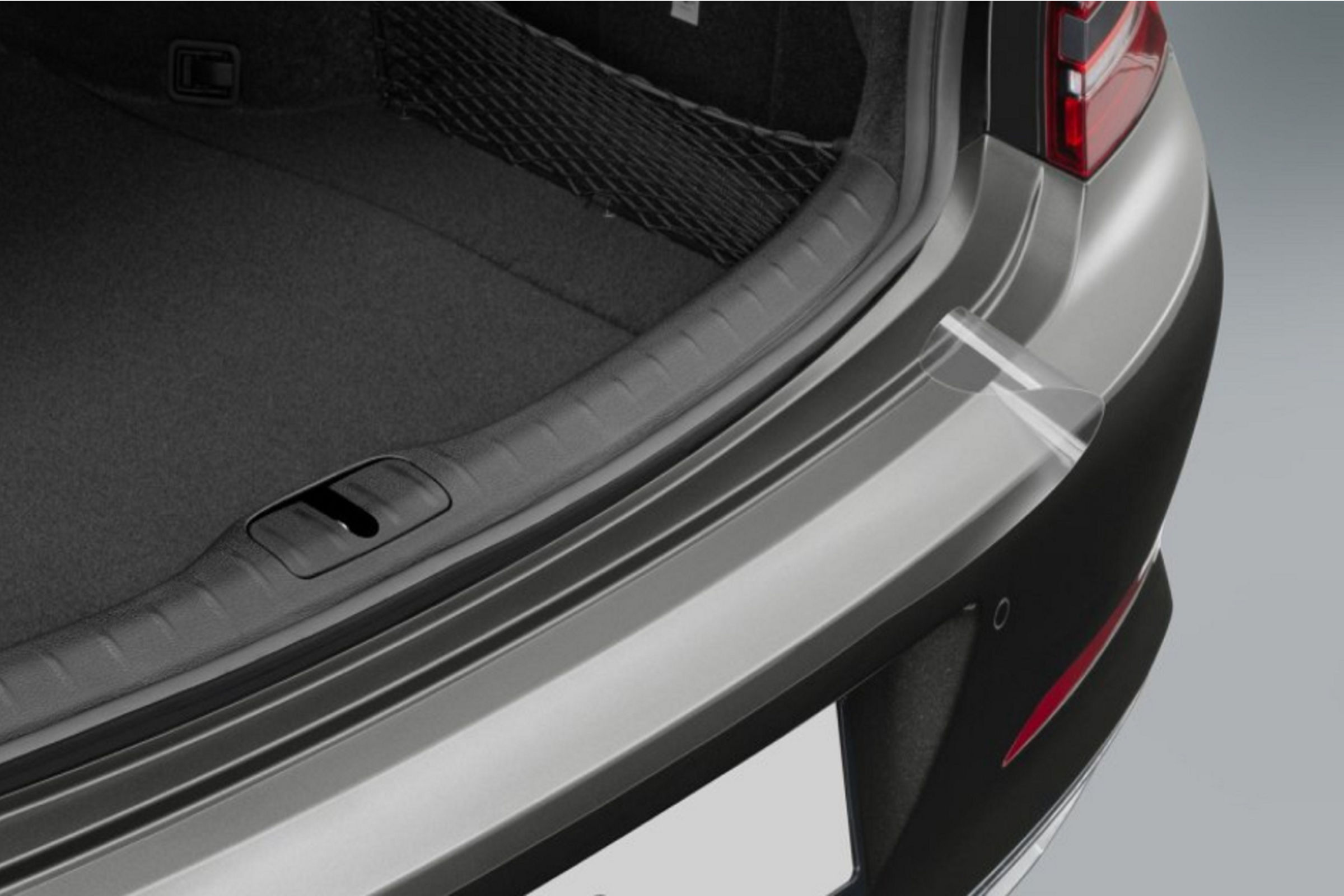 Near-invisible, hardwearing rear sill protector film for loading and unloading protection of Electrified G80.