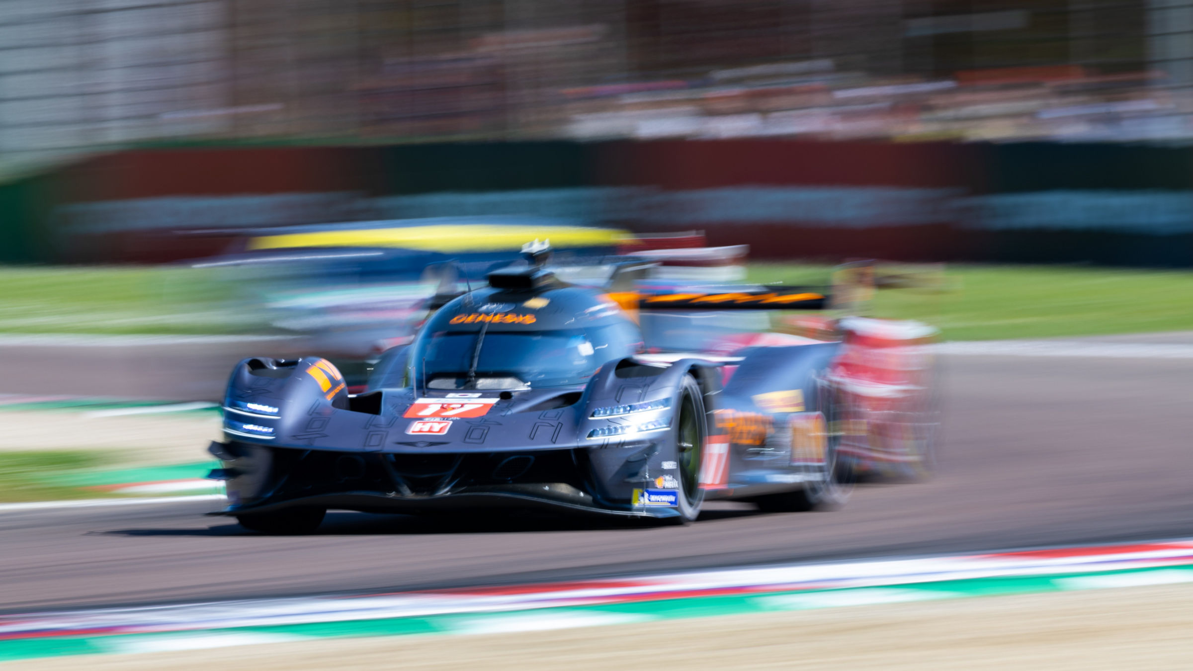 Dynamic shot of the Genesis GRM-001 in motion with colorful track edges.