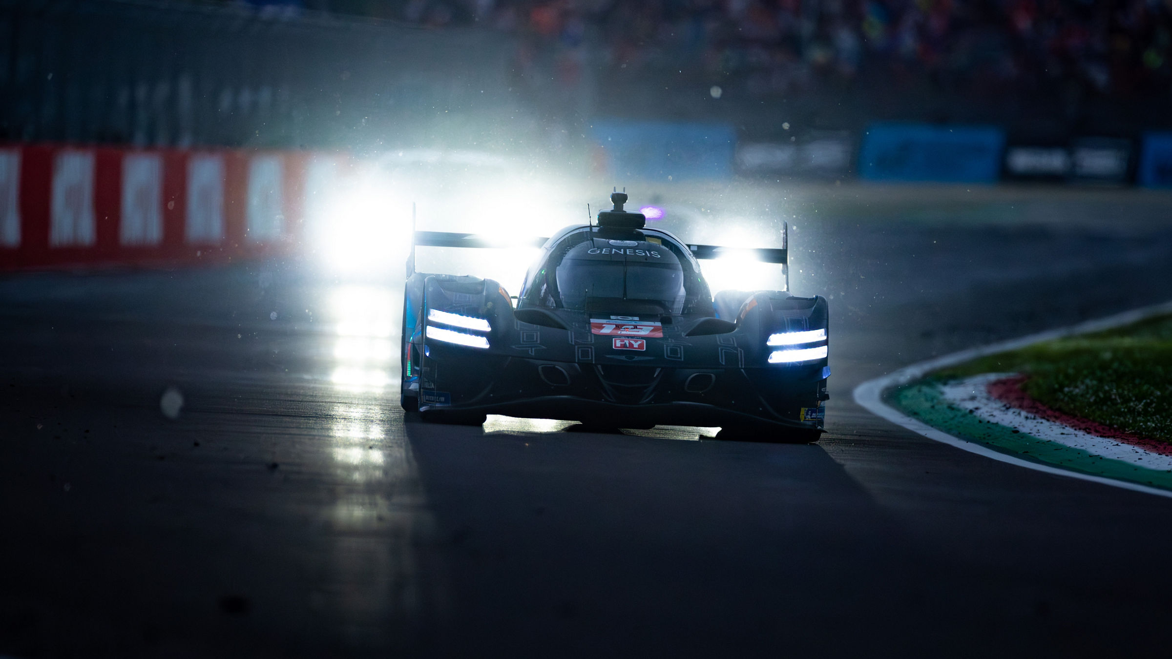 Front view of Genesis GRM-001 on damp circuit with water mist and glowing lights.