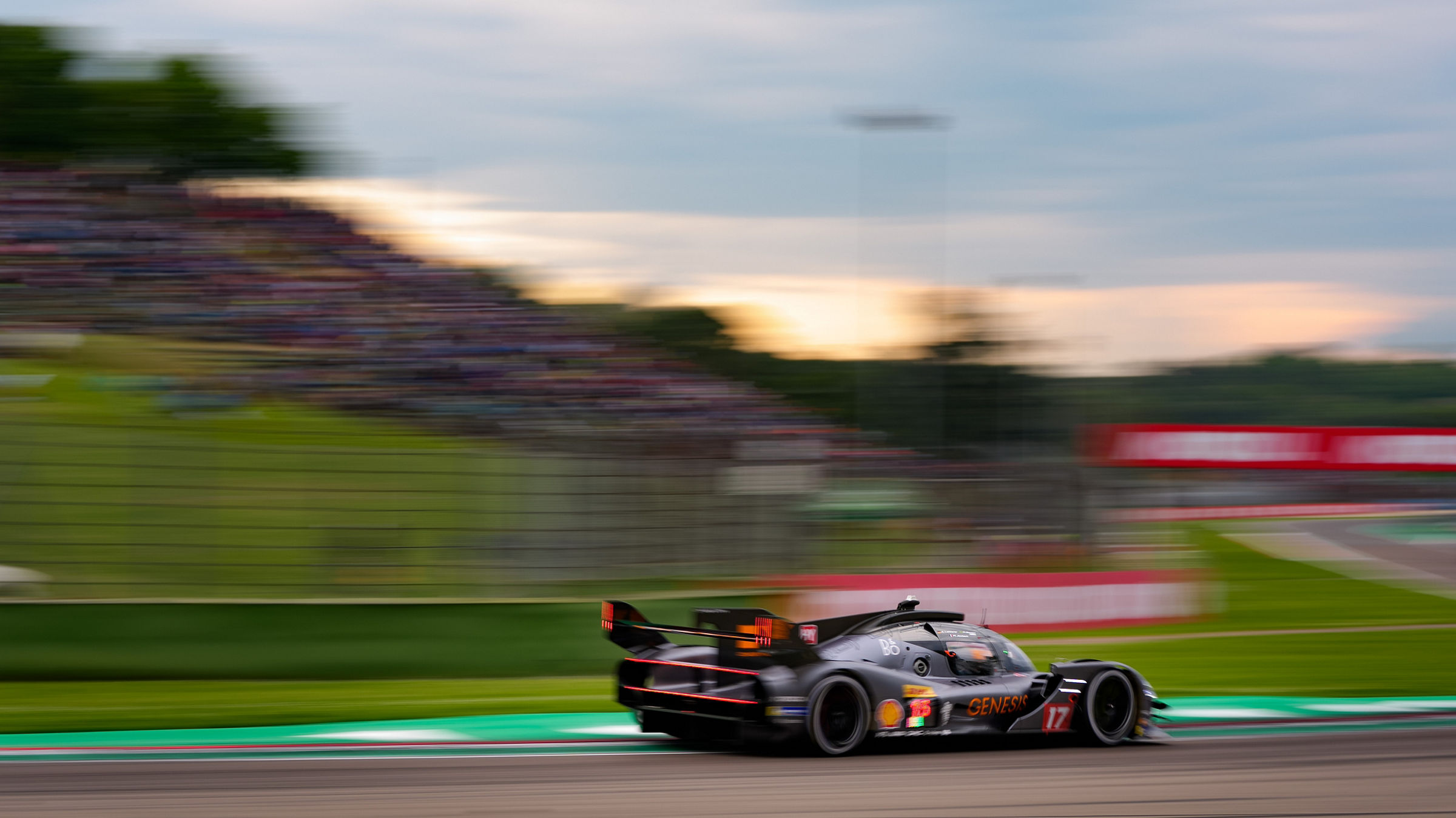 Blurred motion shot of GRM-001 on circuit with spectators.