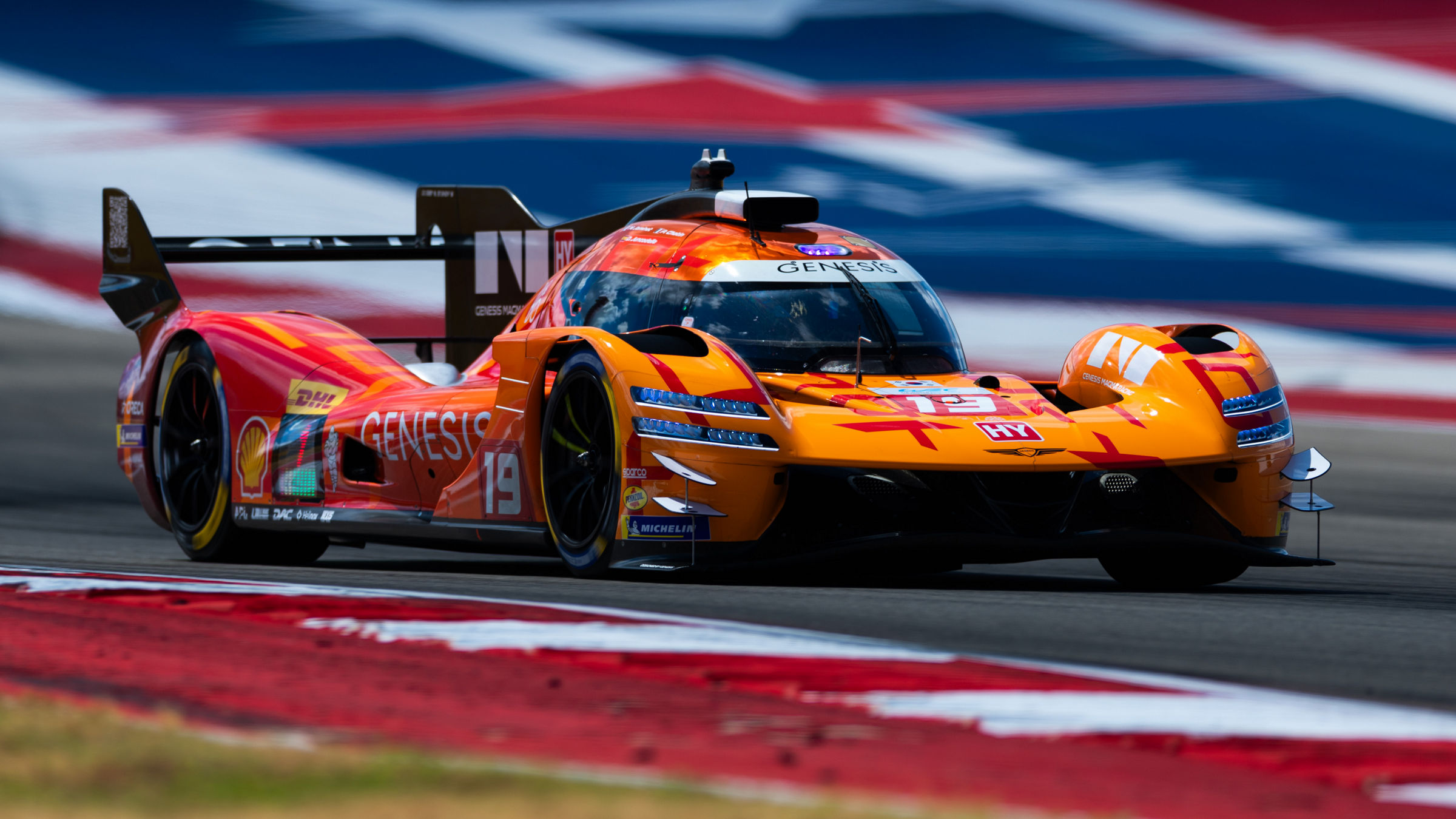 Genesis GMR-001 speeds past COTA's distinctive star-themed runoff area during Lone Star Le Mans.