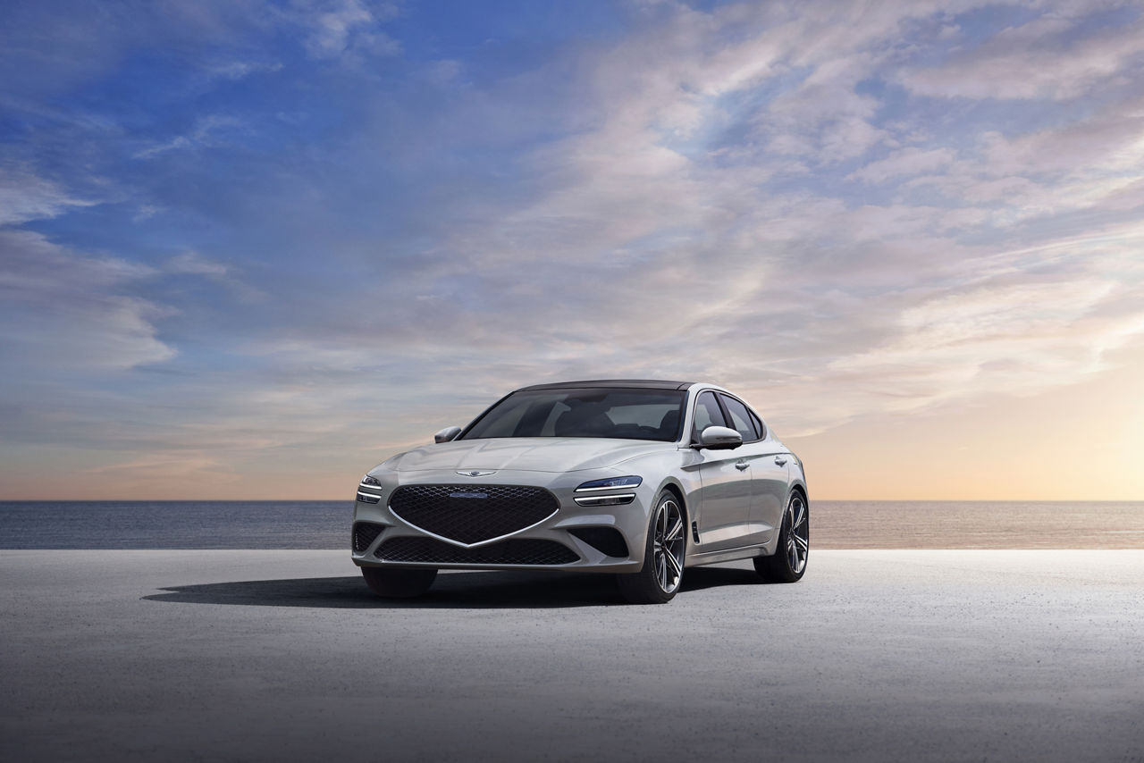 Grey Genesis G70 from the front with the sea in the background