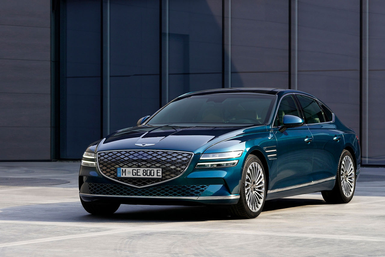 Blue Genesis G80 from the front in front of a dark wall