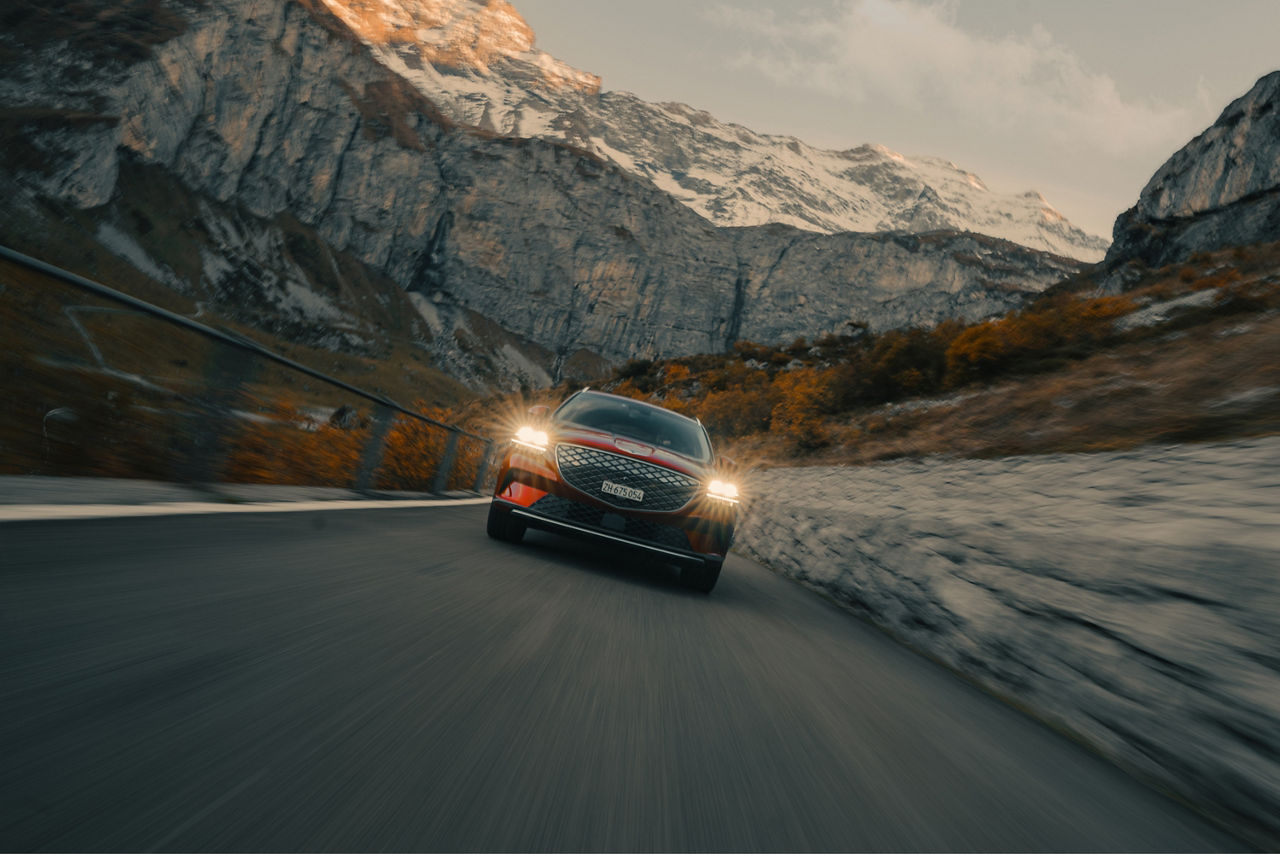 Genesis GV70 from the front on a road in the mountains