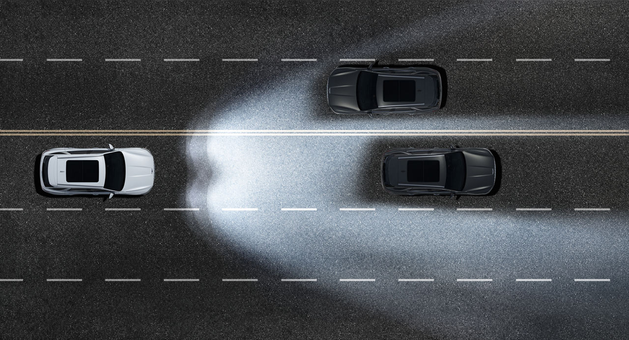 Graphic of the light cone of the headlights of a car on a road with two other cars in the dark