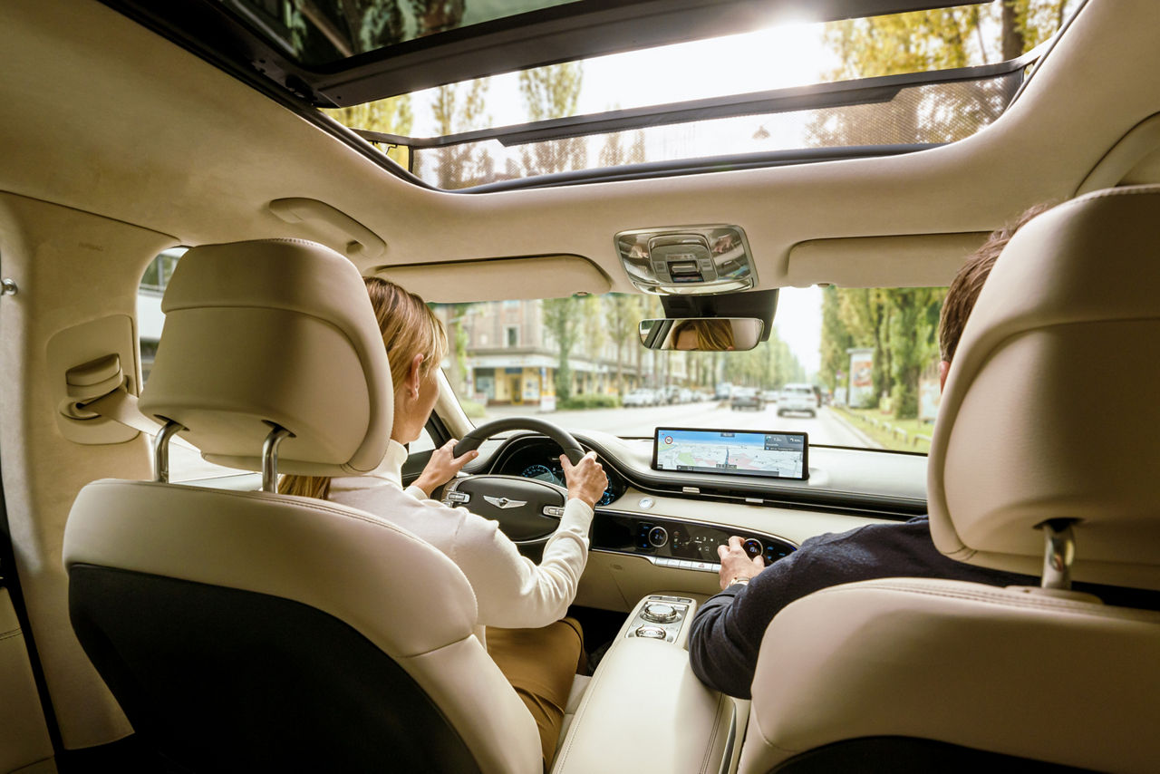 Interior shot of a car with a woman at the wheel and a man in the passenger seat