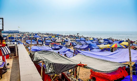People enjoying the beauty of sea and beach by the sea shore in different ways of their own. Puri, India, Asia, February 2020.PURI A renound city,beach resort in the beach of bay of Bengal, Odisa, India.