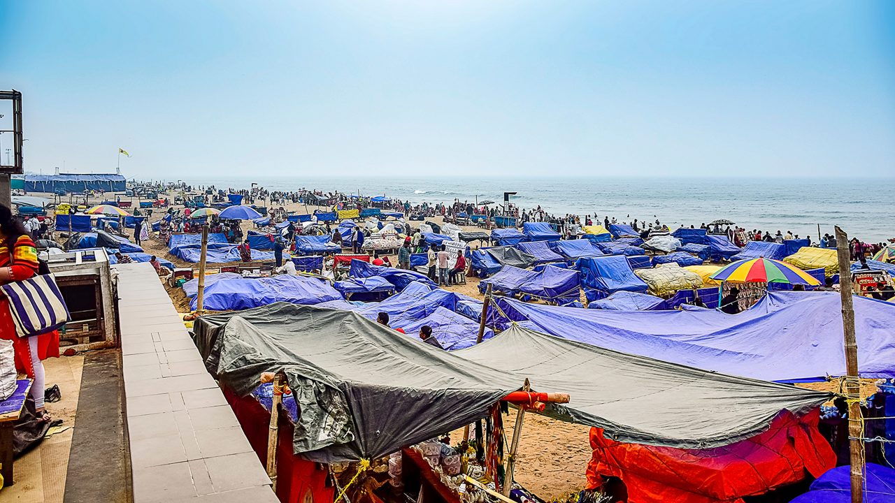 People enjoying the beauty of sea and beach by the sea shore in different ways of their own. Puri, India, Asia, February 2020.PURI A renound city,beach resort in the beach of bay of Bengal, Odisa, India.