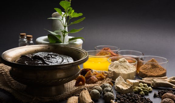 Ayurvedic Chyawanprash is a Powerful  Immunity Booster OR Natural Health Supplement. Served in an Antique bowl with Ingredients, over moody background, selective focus