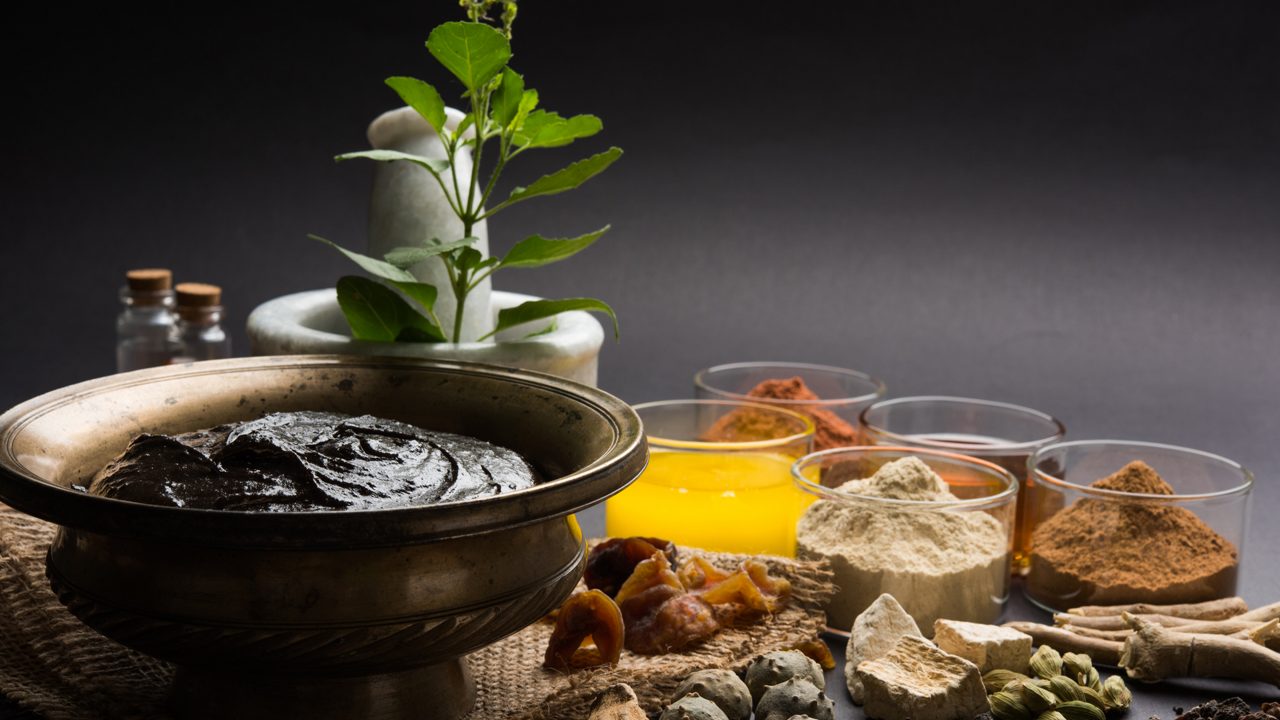 Ayurvedic Chyawanprash is a Powerful  Immunity Booster OR Natural Health Supplement. Served in an Antique bowl with Ingredients, over moody background, selective focus
