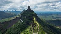 View of stairs and Tungi hill rock, Mangi Tungi, Nashik, Maharashtra, India. Prominent twin-pinnacled peak with plateau in between.