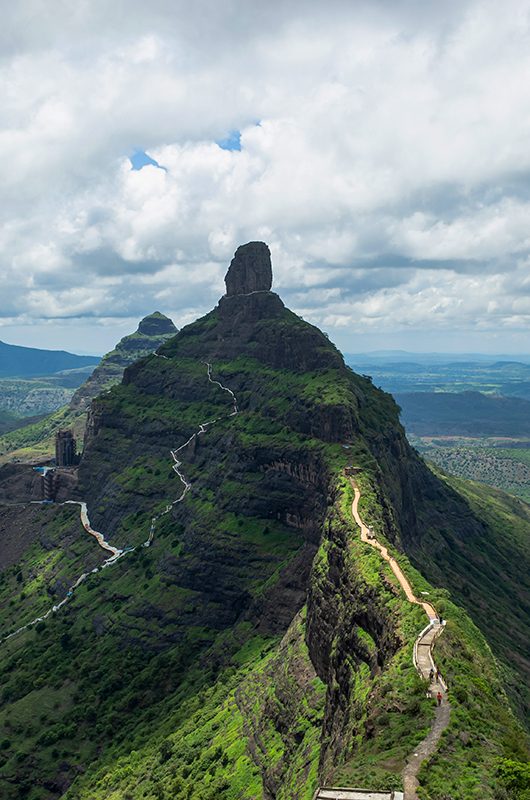 View of stairs and Tungi hill rock, Mangi Tungi, Nashik, Maharashtra, India. Prominent twin-pinnacled peak with plateau in between.