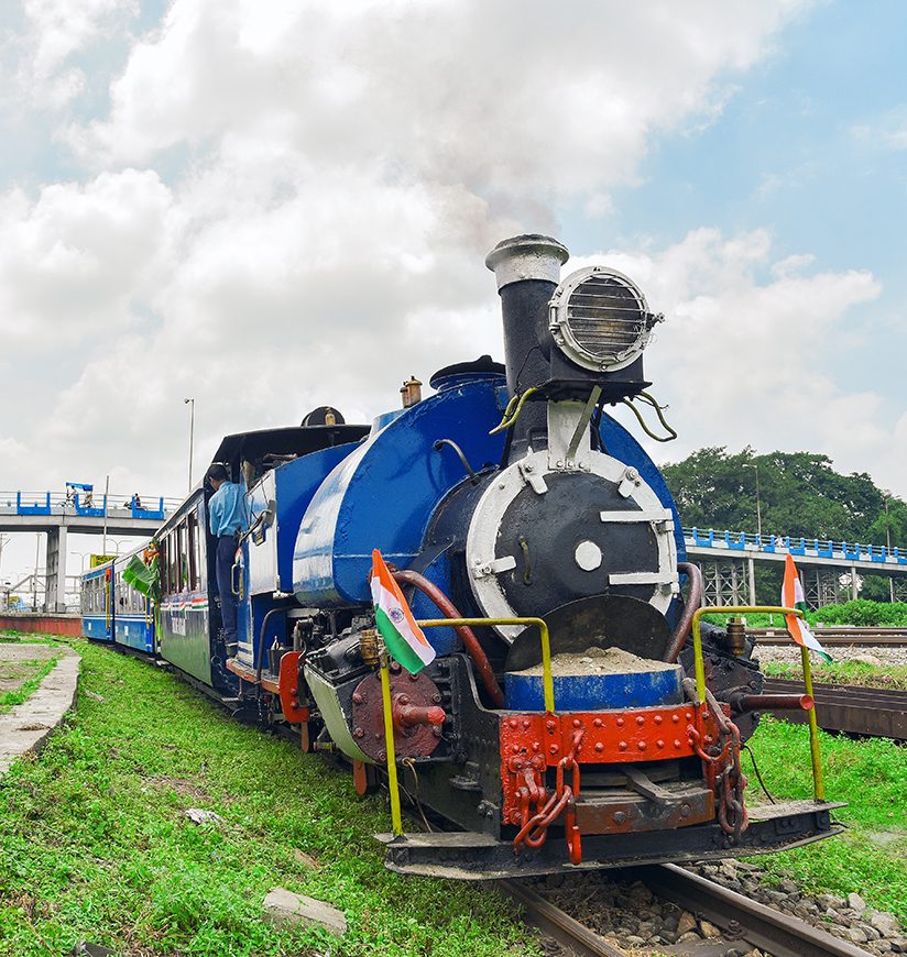 Darjeeling Himalayan Railways toy train heading to the Darjeeling from Siliguri station. The most attractive tourist ride of this region which is recognized as UNESCO world heritage site.; Shutterstock ID 2272049707; purchase_order: -; job: -; client: -; other: -