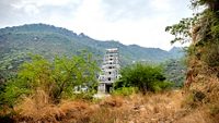 this is the image of marudhamalai Temple coimbatore tamilnadu india. Image is taken with hill in background and bush in front of the temple,; Shutterstock ID 1401703706; purchase_order: -; job: -; client: -; other: -