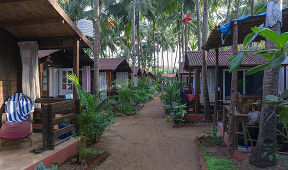 Row of beach huts centred on an interior garden at agonda beach in goa, india