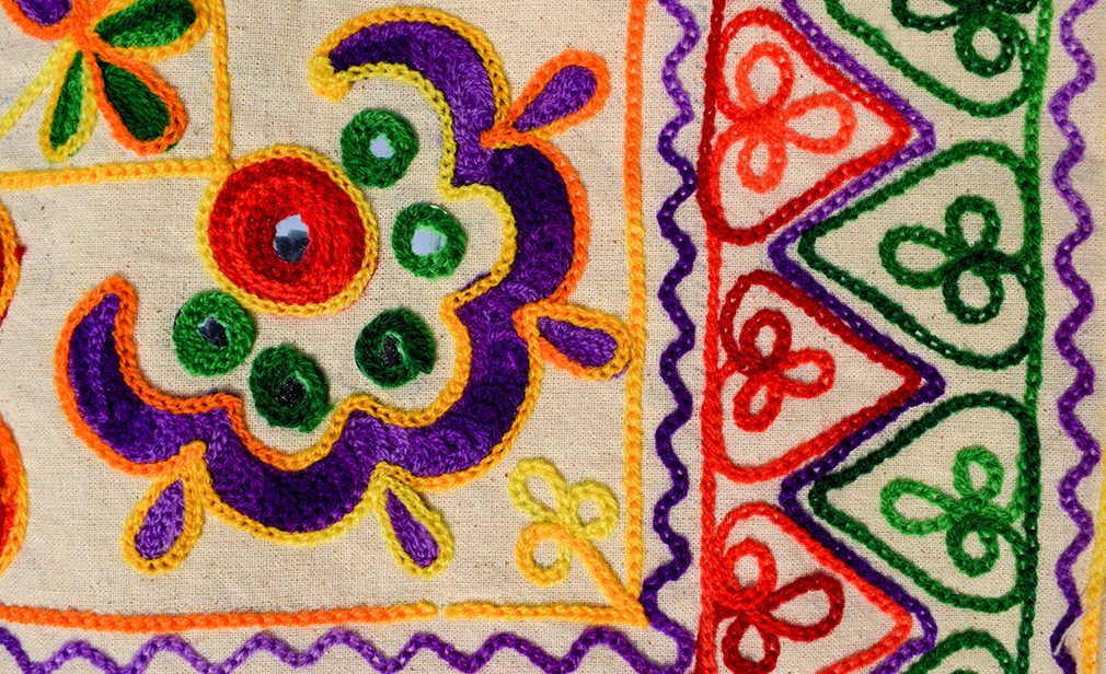 Beautiful embroidery multicoloured hand crafted thread work with mirrorwork from Kutch district bhuj called Kutchi embroidery. Embroidery work backdrop