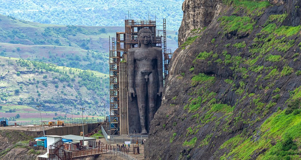 View from Tungi hill of 108 ft Jain Idol of Rishabhdev Bhagwan believed to be the first Tirthankara in Jainism. Mangi Tungi hills. Nashik, Maharashtra, India.