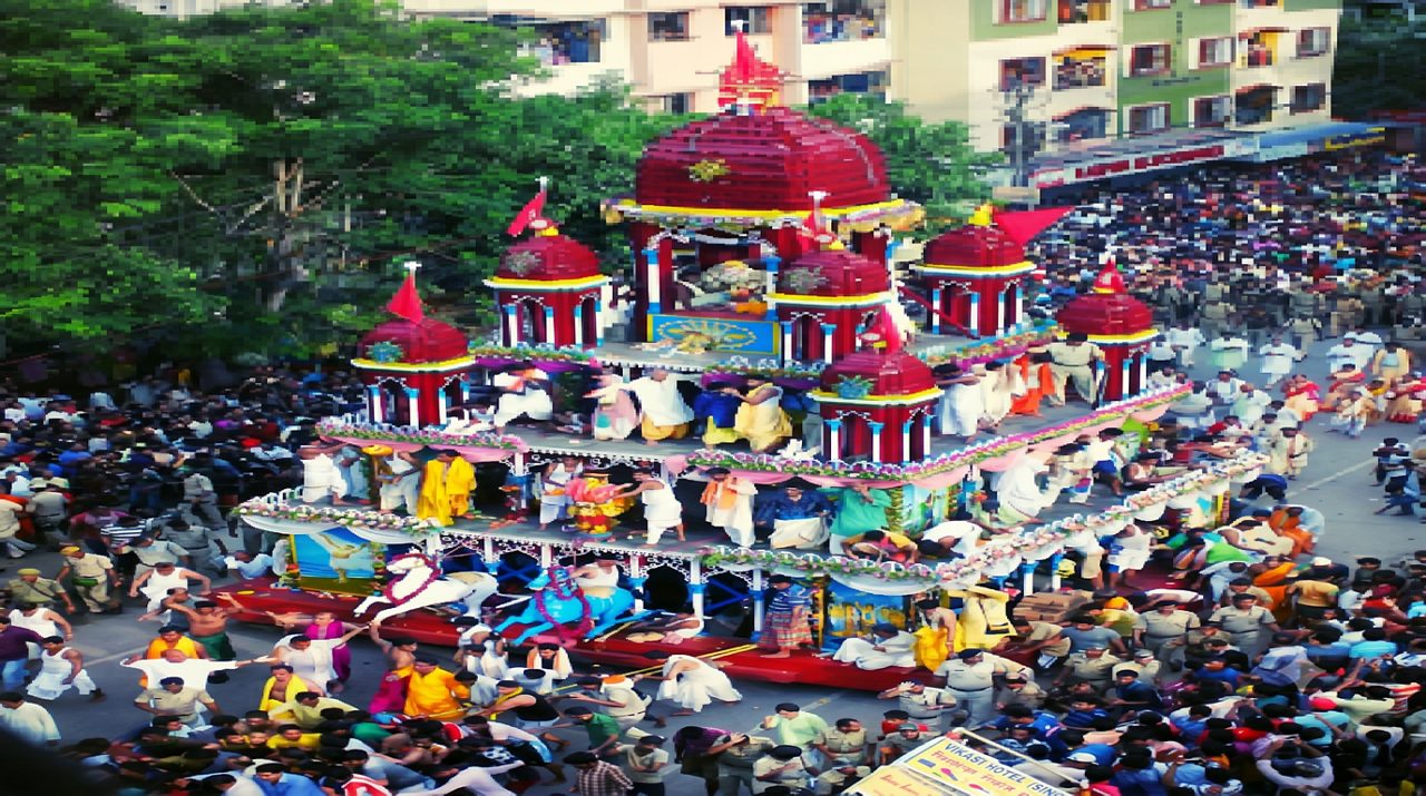 The Mahesh Rath Yatra, celebrated at the historic Mahesh Jagannath Temple in Serampore, West Bengal, is one of India’s oldest and most revered festivals dedicated to Lord Jagannath. Dating back to 1396 AD, it is recognised as the oldest Rath Yatra in Bengal and the second oldest in the world after the famous Puri Rath Yatra. Every year, nearly 2–3 lakh devotees gather to witness the grand procession of Lord Jagannath, along with Lord Balabhadra and Devi Subhadra. The Mahesh Jagannath Temple was founded by saint Drubananda Brahmachari, who is believed to have received divine blessings from Lord Jagannath. The temple later flourished under Kamalakar Pippalai and was restored in the 19th century by Nayanchand Mallick and his son Nimai Charan. The highlight of the festival is the majestic 50-foot-tall iron chariot built in 1885 by Martin Burn Company. Weighing around 125 tonnes, the grand chariot is pulled by thousands of devotees through the streets amid devotional chants and music. Along with sacred rituals and a vibrant fair, the Mahesh Rath Yatra beautifully reflects Bengal’s devotion, heritage, and cultural spirit.