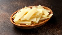 Sliced canned bamboo shoots in wooden bowl.
