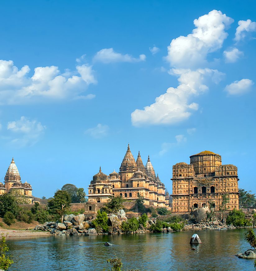 Water rafting on Betwa river in front of Royal cenotaphs (Chhatris). Orchha, Madhya Pradesh, India.