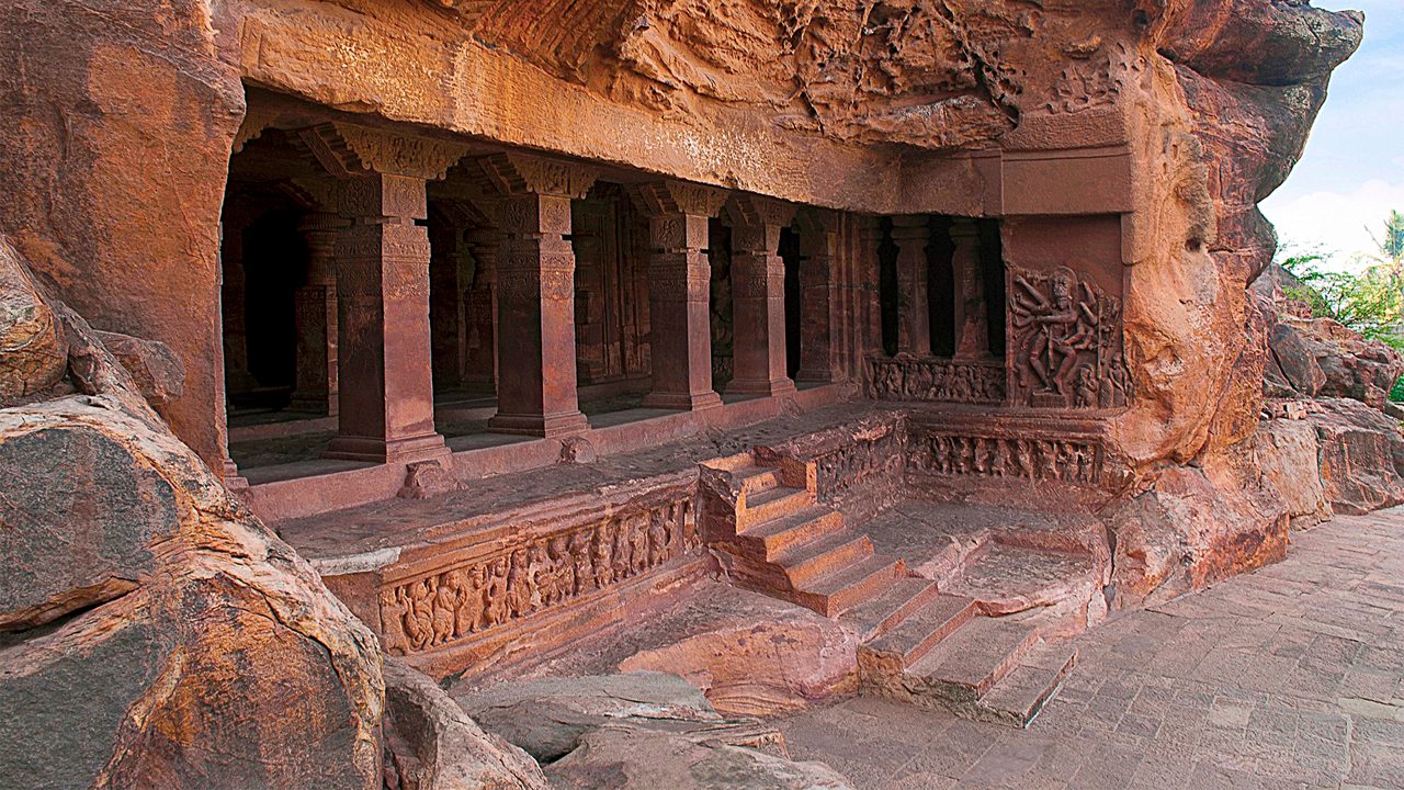 Cave 1 : Facade. Badami Caves, Karnataka, India. Depicting carvings of dwarfish ganas, with bovine and equine heads, in different postures.