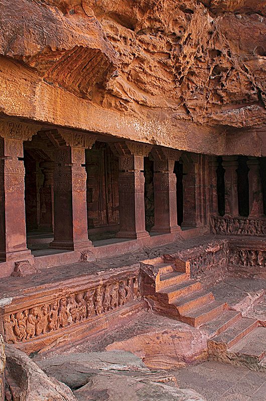 Cave 1 : Facade. Badami Caves, Karnataka, India. Depicting carvings of dwarfish ganas, with bovine and equine heads, in different postures.