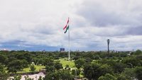 Indian Flag fluttering in the wind under monsoon clouds at Central Park in Jaipur, Rajasthan