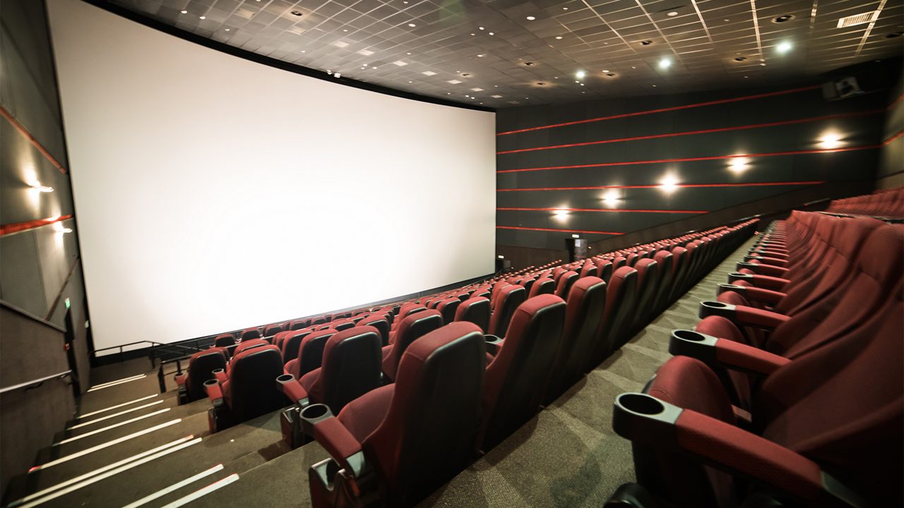 Empty cinema auditorium with screen and seats. Mock Up.