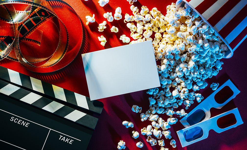 Blank cinema promo card or ticket, popcorn, filmstrip and clapper, movies and entertainment concept